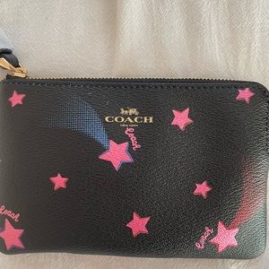 Brand new COACH leather wristlet with pink accents.